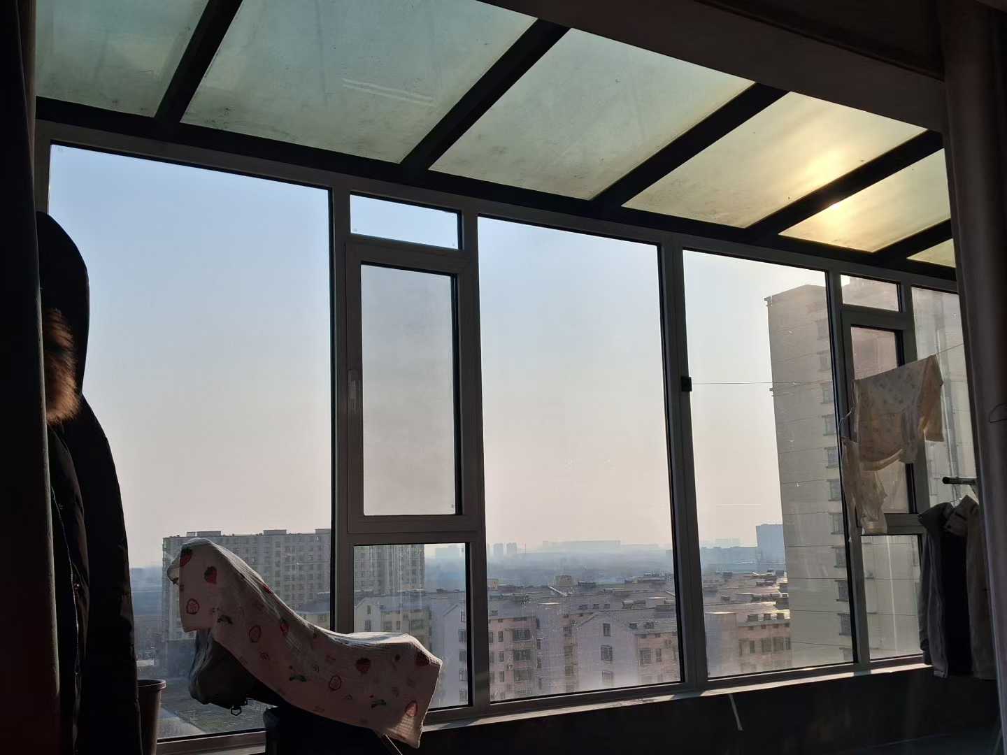 Large aluminum sliding window overlooking a balcony